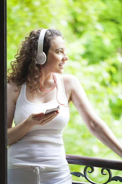 스마트 폰에서 음악을 듣는 젊은 여성 — 스톡 사진