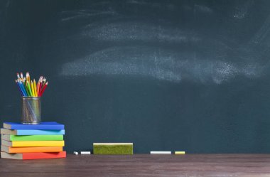 Okul öğretmeninin masasında ki kitaplarda kalemlik