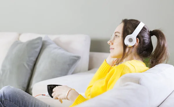 Mujer joven escuchando música en casa — Foto de Stock