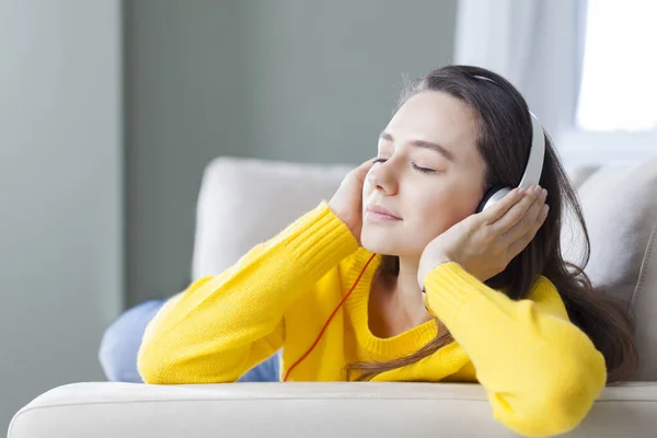 Mujer joven escuchando música con auriculares — Foto de Stock