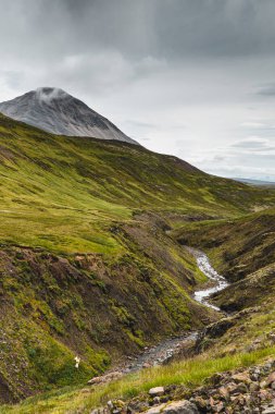 Bulutlu bir günde İzlanda Nehri Arka Ülkeyi Kesiyor