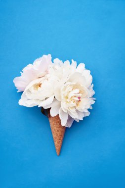 Parlak mavi ba beyaz şakayık çiçekleri ile Waffle dondurma konisi