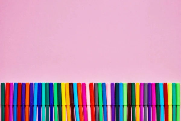 Obramowanie kolorowych długopisów z filcu na różowym tle z miejscem na tekst. Widok z góry, miejsce kopiowania tekstu. — Zdjęcie stockowe