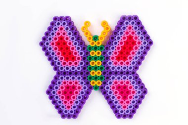 Perler bead butterfly. Close up. White isolated background. clipart