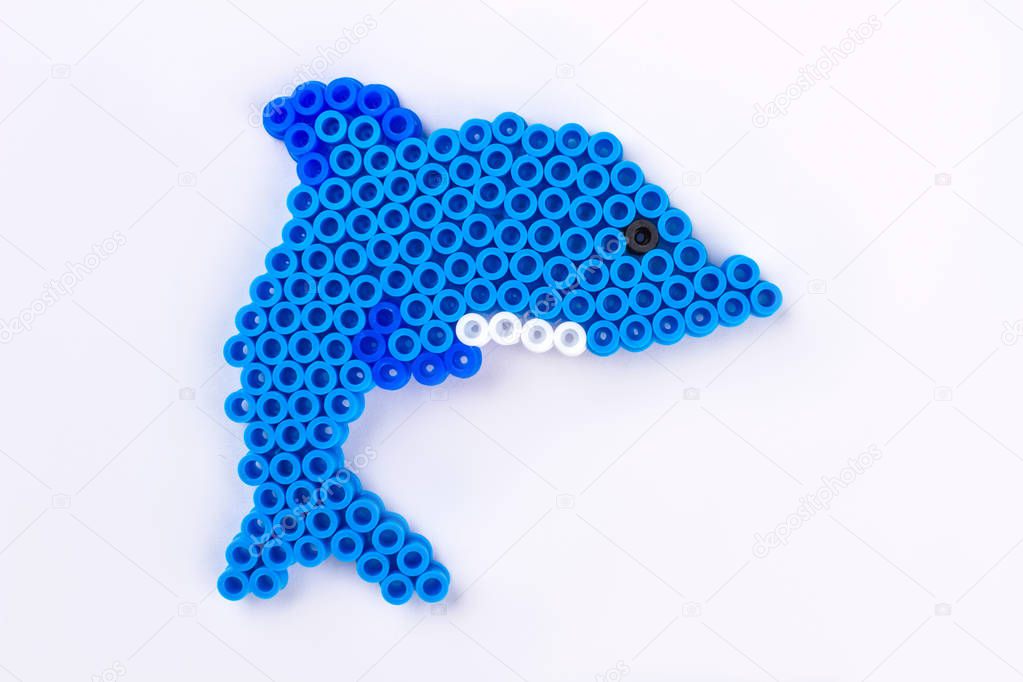 Perler bead dolphin. Close up. White isolated background.