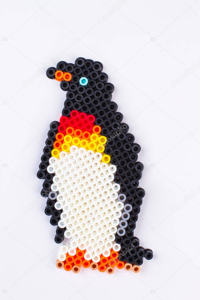 Penguin perler beads. Close up. White isolated background.