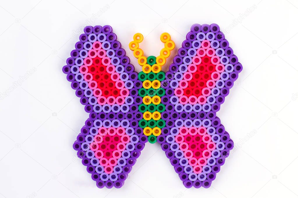 Perler bead butterfly. Close up. White isolated background.