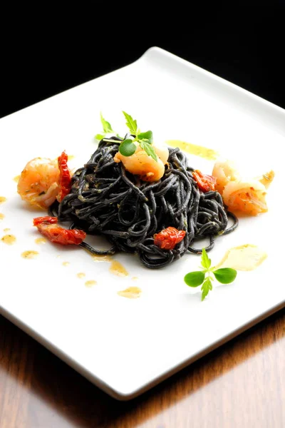 Fine dining, Italian squid ink pasta — Stock Photo, Image