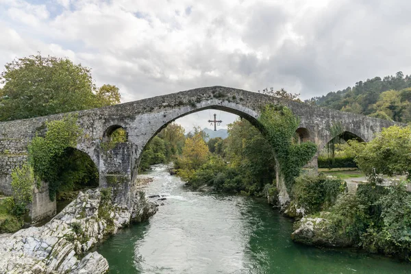 İspanya 'nın Cangas de Onis kentindeki Roma köprüsünde zafer haçı kemerde asılı.