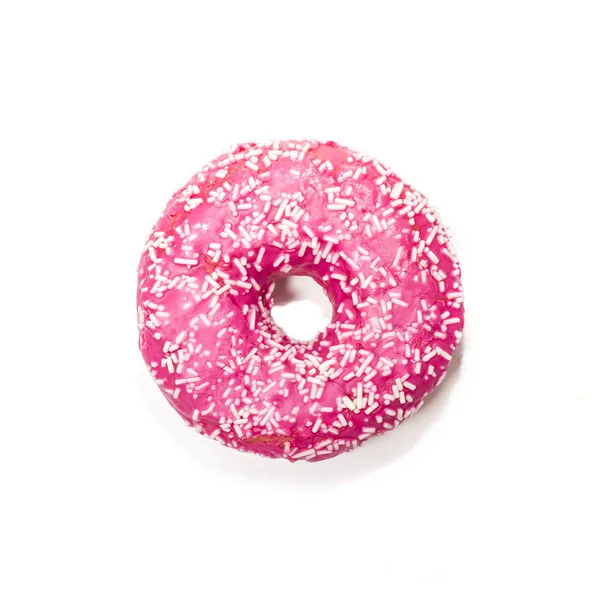 Розовый пончик с белыми брызгами на белом фоне — стоковое фото