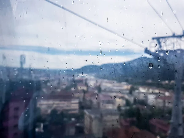 Regn Fönstret Linbanan Och Suddig Stad Och Kraftledningar — Stockfoto