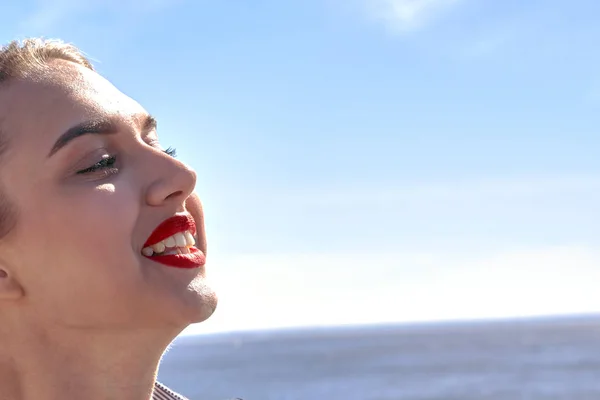 Rostro de una chica feliz sobre un fondo de mar y cielo —  Fotos de Stock
