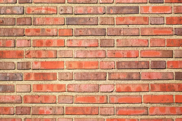 Red brick background with a thick layer of cement, a fragment of