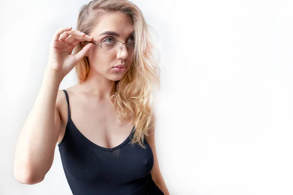 Beautiful blonde looks over glasses on her face — Stock Photo, Image