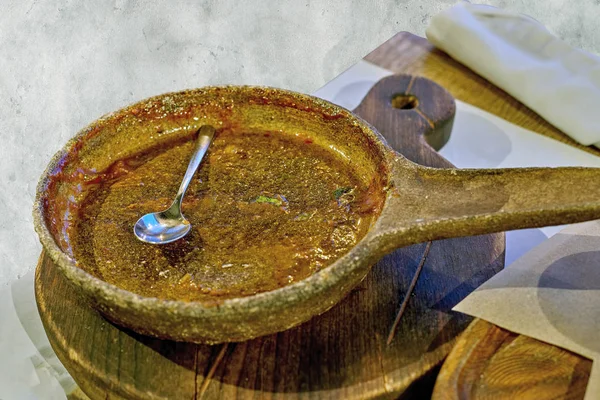 Empty dirty pan and spoon after dinner on the table — Stock Photo, Image