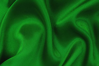 Arkaplan ve tasarım için koyu yeşil kumaş dokusu, güzel buruşmuş ipek ya da keten deseni..
