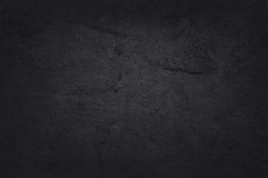 Koyu gri kayrak dokusu yüksek çözünürlüklü, arka planda siyah taş duvar var..