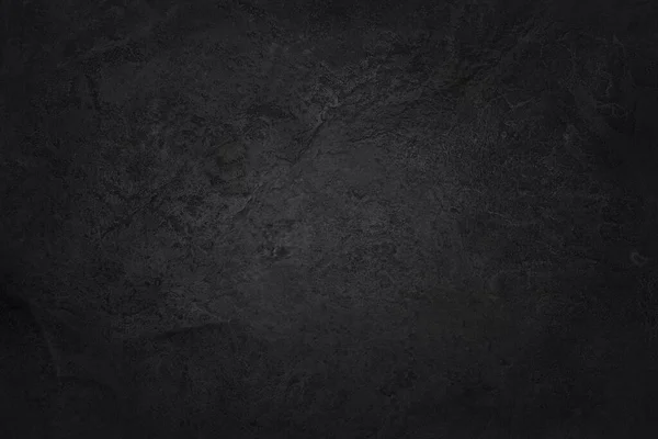 Koyu gri kayrak dokusu yüksek çözünürlüklü, arka planda siyah taş duvar var..