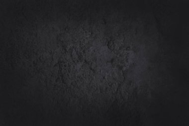 Koyu gri kayrak dokusu yüksek çözünürlüklü, arka planda siyah taş duvar var..