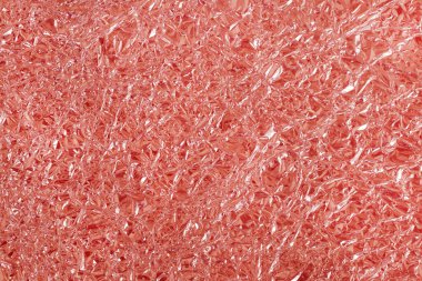 Gül sarısı folyo parlak doku, arkaplan ve tasarım çalışmaları için soyut kırmızı ambalaj kağıdı.