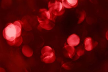 Kırmızı bokeh arkaplan, noel ve sevgililer günü için bulanık parlak bir ışık..