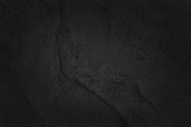 Koyu gri kayrak dokusu yüksek çözünürlüklü, arka planda siyah taş duvar var..