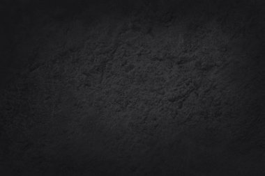 Koyu gri kayrak dokusu yüksek çözünürlüklü, arka planda siyah taş duvar var..