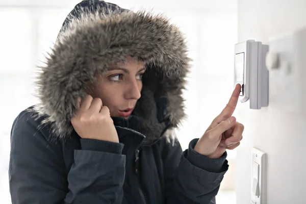 Mujer con ropa cálida sintiendo el frío dentro de casa —  Fotos de Stock