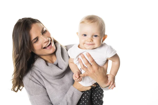 Una madre sostiene a su bebé en el fondo blanco del estudio — Foto de Stock