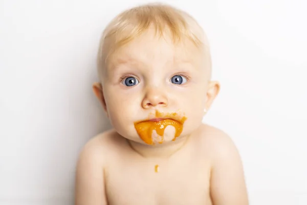 An Adorable baby girl making a mess while feeding herself — Stock Photo, Image