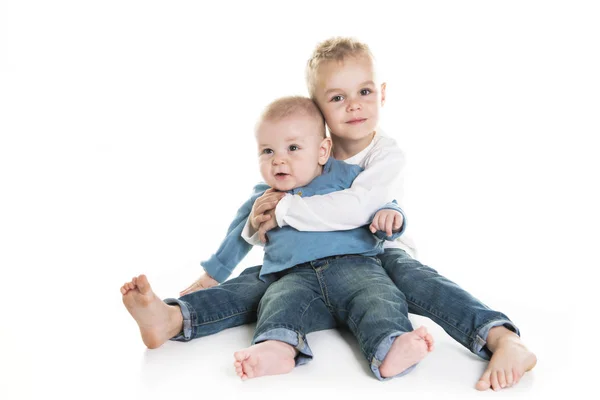 Two brother sit on the studio white background — Stock Photo, Image