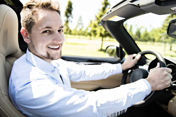 Hombre de negocios guapo en un coche descapotable —  Fotos de Stock