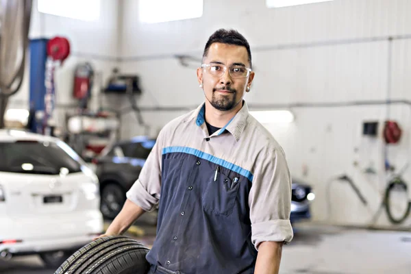 Pneu mecânico de mudança de carro no trabalho — Fotografia de Stock