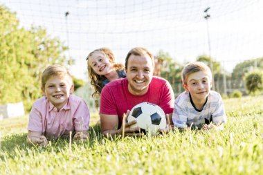 A Happy family lifestyle play soccer outside clipart
