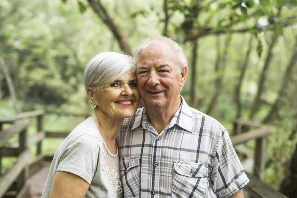 Happy old elderly caucasian couple in a park — Stock Photo, Image