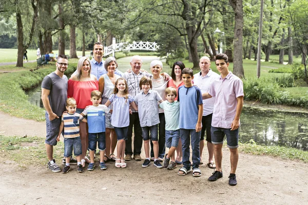 Large family with cousin grandparent father and kid on a forest — Stock Photo, Image