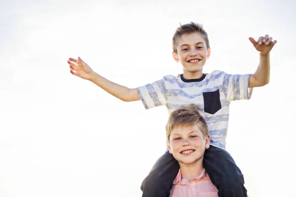 Portrait of two happy cheerful brothers at sunset, outdoor — Stock Photo, Image