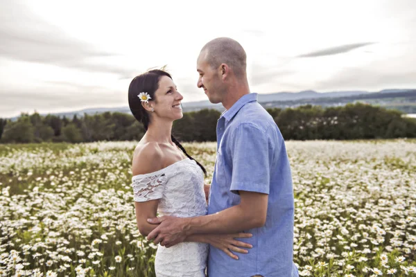 Par i kärlek utomhus på den solnedgången daisy — Stockfoto