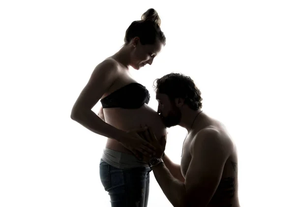 Against the light portrait of pregnant couple — Stock Photo, Image