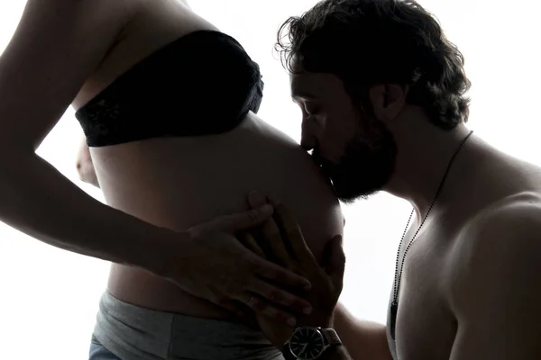 Against the light portrait of pregnant couple — Stock Photo, Image