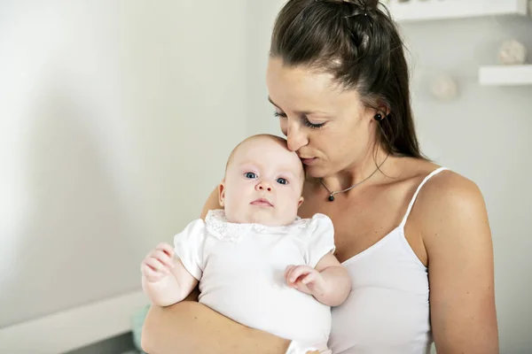 Egy gyönyörű anya portréja 2 hónapos kisbabájával a hálószobában — Stock Fotó