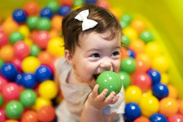 Portrait of a adorable infant on colorful balls — Stock Photo, Image