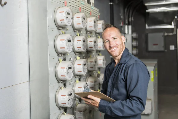 Man Technician servicing at work on electric room — Stock Photo, Image