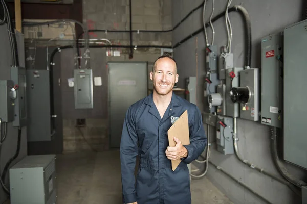 Man Technician servicing at work on electric room — Stock Photo, Image