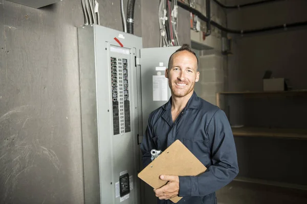 Man Technician servicing at work on electric room — Stock Photo, Image