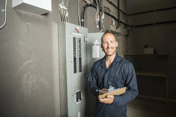 Man Technician servicing at work on electric room — Stock Photo, Image