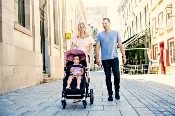 Family taking a walk down the street — Stock Photo, Image