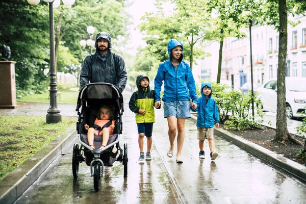 Family with childs walk on rainy day with raincoat — Stock Photo, Image