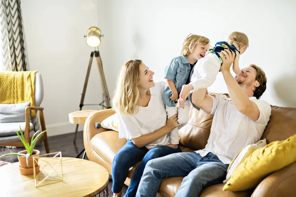 Family having fun on sofa. — Stock Photo, Image
