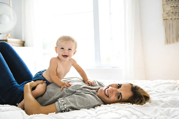 Mãe e bebê menina Em cima da cama — Fotografia de Stock